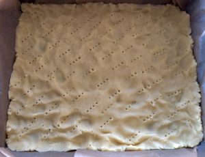 Spód na kruche ciasto z bezą i truskawkami przygotowany do pieczenia.